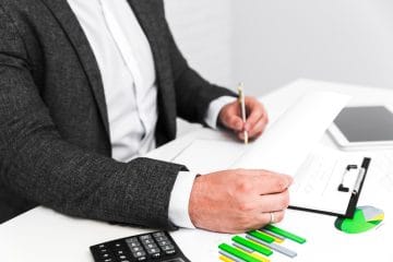 Audit manager reviewing financial statements with an audit team in the office